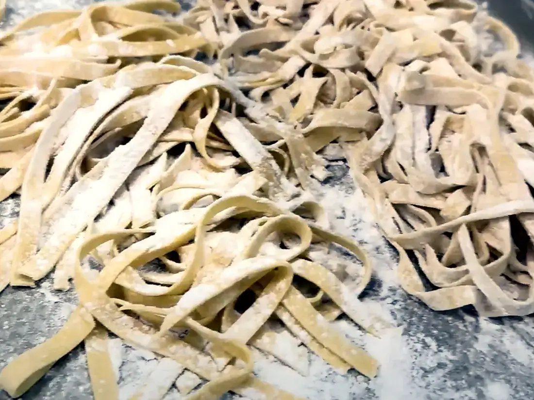 Fresh hand-cut tagliatelle dusted with flour