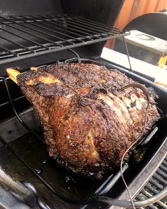 A whole roast of dry-aged beef, crusted and rested on a rack